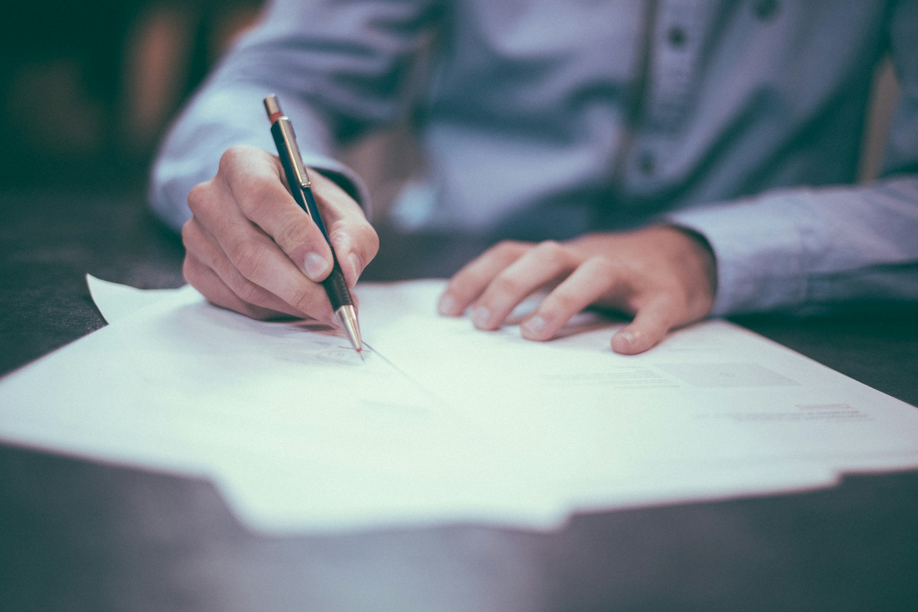 Reviewing and signing legal documents at a desk